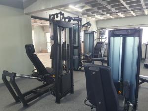 a gym with treadmills and chairs in a room at Flat Beach Class Executive in Recife