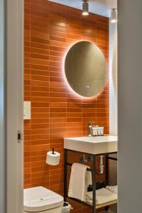 a bathroom with a toilet and a sink and a mirror at Ahoy Plaza Mayor in Elda +27 photos