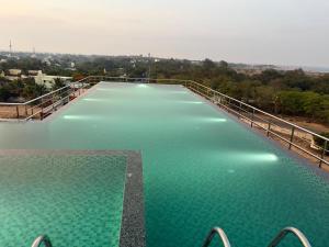 a large pool of green water on a bridge at Sri Vasavi Regency in Mahabalipuram