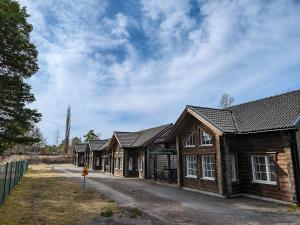 a row of wooden houses with a sky at Värdshuset Flottaren in Vansbro