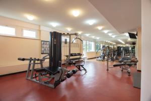 a gym with a row of treadmills and machines at Hotel Roma Aurelia Antica in Rome