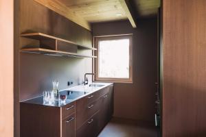 a kitchen with a sink and a window at Ferienhaus Islen in Mellau +75 photos