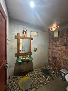 a bathroom with a sink and a stone wall at Highway 20 Homestay in Phong Nha