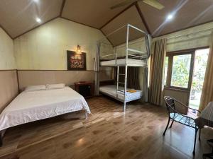 a bedroom with two bunk beds in a room at Highway 20 Homestay in Phong Nha