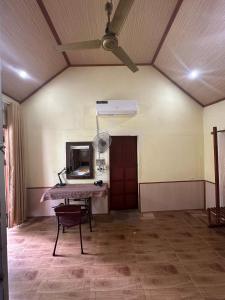 a room with a table and a mirror on the wall at Highway 20 Homestay in Phong Nha