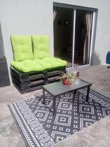 a green couch in a living room with a coffee table at Kaye Daisy in Vieux Fort +1 photo