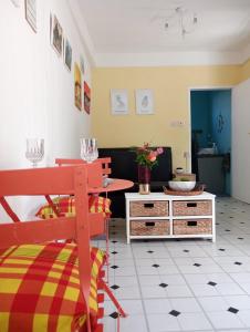 a living room with a red bench and a table at Kaye Daisy in Vieux Fort