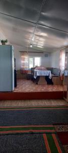 a living room with a table in the middle of a room at STALBEK Guest House in Kochkorka