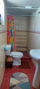 a bathroom with a toilet and a sink at STALBEK Guest House in Kochkorka +15 photos