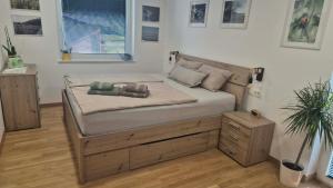 a bedroom with a large bed with a wooden frame at Ta World apartments in Spodnji Log