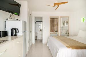 a white bedroom with a bed and a kitchen at Vittorio Fabulous View in Tías +14 photos
