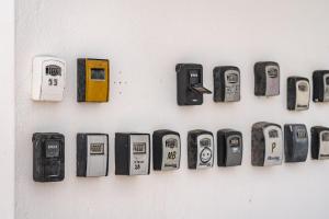a bunch of cell phones hanging on a wall at Vittorio Fabulous View in Tías