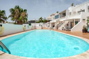 a large swimming pool in front of a building at Vittorio Fabulous View in Tías