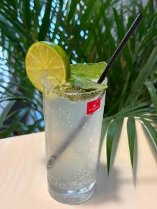 a glass of water with a lime on a table at Hotel Sweet Night in Kazbegi