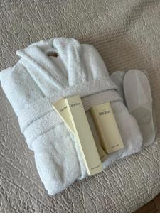 two books on a white towel on a bed at Hotel Sweet Night in Kazbegi +261 photos