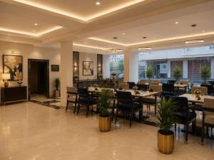a restaurant with tables and chairs in a room at IndiGo Line Hotel - Opp Paradise Biryani Shamshabad in Hyderabad +25 photos