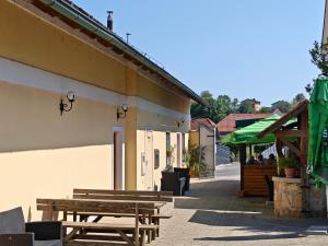 a group of benches sitting outside of a building at Center Grič - sobe, apartma in Sveta Trojica v Slovenskih Goricah