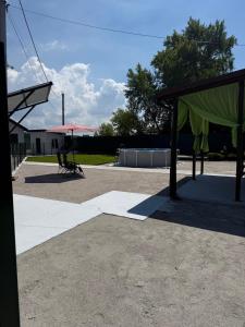 a shelter with a green covering in a parking lot at Будинок на Дніпрі in Kozin +3 photos