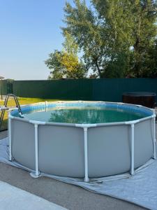 a large circular pool with a metal coping around it at Будинок на Дніпрі in Kozin