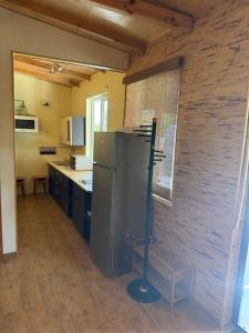 a kitchen with a stainless steel refrigerator in a room at Будинок на Дніпрі in Kozin