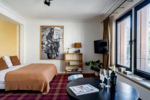 a hotel room with a bed and a table at A Place Antwerp - Boutique Suites & Flats - Vrijdagmarkt 1 in Antwerp