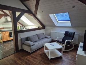 a living room with a couch and a table at Ferienwohnung Moos in Haiger