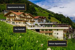 a group of buildings on a grassy hill at Apparthotel Sonnwies in Selva dei Molini