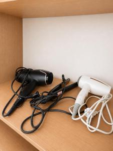 a desk with a hair dryer and other office equipment at 신사 여성전용 개인 미니룸 Female Only Private Mini Room Gosiwon 2pm ckeck in 11am ckeck out address 강남구 논현동6-8 BESTEL, Check the message for the check in in Seoul