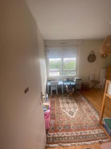 a living room with a table and a window at Appartement Antoine in Rennes +2 photos