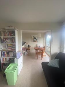 a living room with a table and a dining room at Appartement Antoine in Rennes