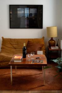 a living room with a table with wine glasses on it at A Place Antwerp - Boutique Suites & Flats - Vrijdagmarkt 1 in Antwerp
