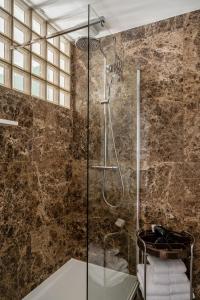 a bathroom with a shower with a glass door at A Place Antwerp - Boutique Suites & Flats - Vrijdagmarkt 1 in Antwerp +71 photos
