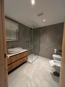 a bathroom with a tub and a sink and a shower at Ma Chérie in Livigno