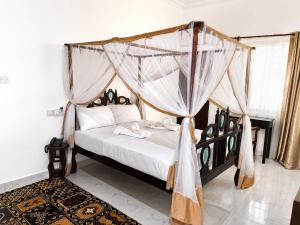 a bedroom with a bed with a canopy at Lamu Creek Hotel in Lamu +30 photos
