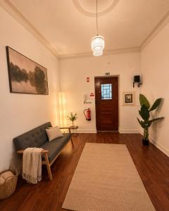 a living room with a couch and a table at Casa do Jardim in Peniche
