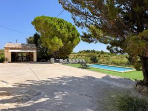 a villa with a swimming pool and a house at Casa Rural Cal Martí in El Pla de Manlleu