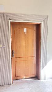 a large wooden door in a building at شقة استديو in Al Baha
