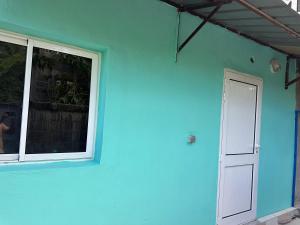 a blue building with a window and a door at Ouzouri Wa Lijou in Mzouazia