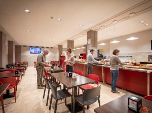 a group of people preparing food in a restaurant at Hotel Miramonti in Turin