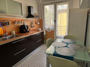 a kitchen with a table with plates on it at KALEIDO Hostel in Genoa