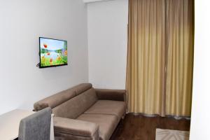 a living room with a brown couch in a room at Villa Blanco in Mostar