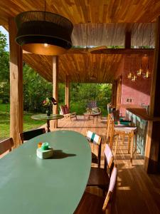 a patio with a green table and chairs at Passion Fruit Lodge in Cahuita