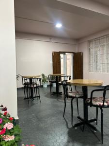 a group of tables and chairs in a room at Serenity View Stay in Shillong