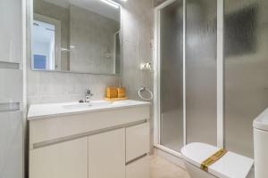a bathroom with a shower and a sink and a toilet at Apt Italia 96 in Almarda +13 photos