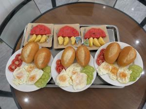 a tray with plates of breakfast food on a table at HagiangTrips Hotel in Ha Giang