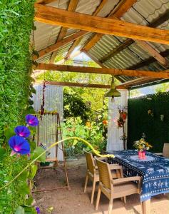 a patio with a table and chairs under a pergola at Getaway Nook in Dedoplis Tskaro