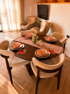 a living room with a table with chairs and a couch at Monte Casa Žabljak in Žabljak