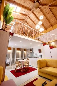 a kitchen and living room with a table and chairs at Orama Suite & Spa in Korçë