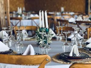 a table with glasses and napkins on top of it at Yes We Camp Agafay Luxury Khaïma & Restaurant - Spa in El Karia +121 photos