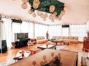 a living room with a couch and a table at Yes We Camp Agafay Luxury Khaïma & Restaurant - Spa in El Karia
